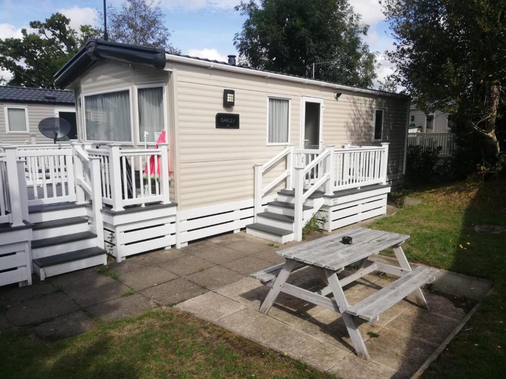 a picnic table in front of a tiny house at narcissus in Ferndown
