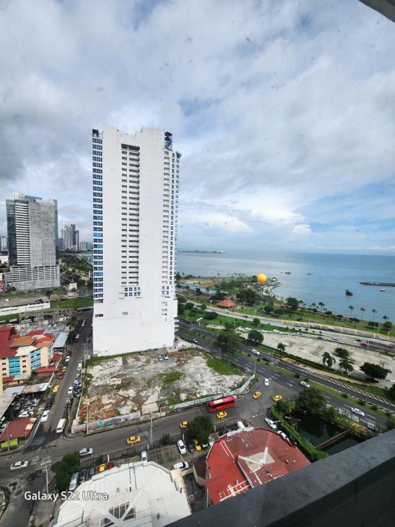 a city with two tall white buildings and the ocean at Casa Hany in Panama City