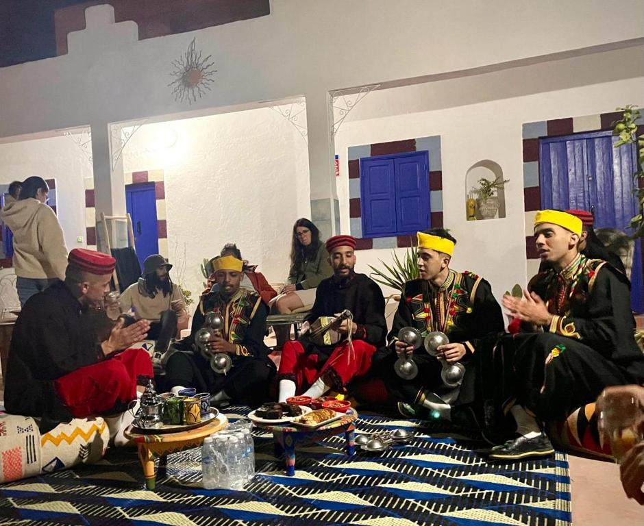a group of men wearing turbans sitting in a room at Riad Dar Sarah in Taghazout