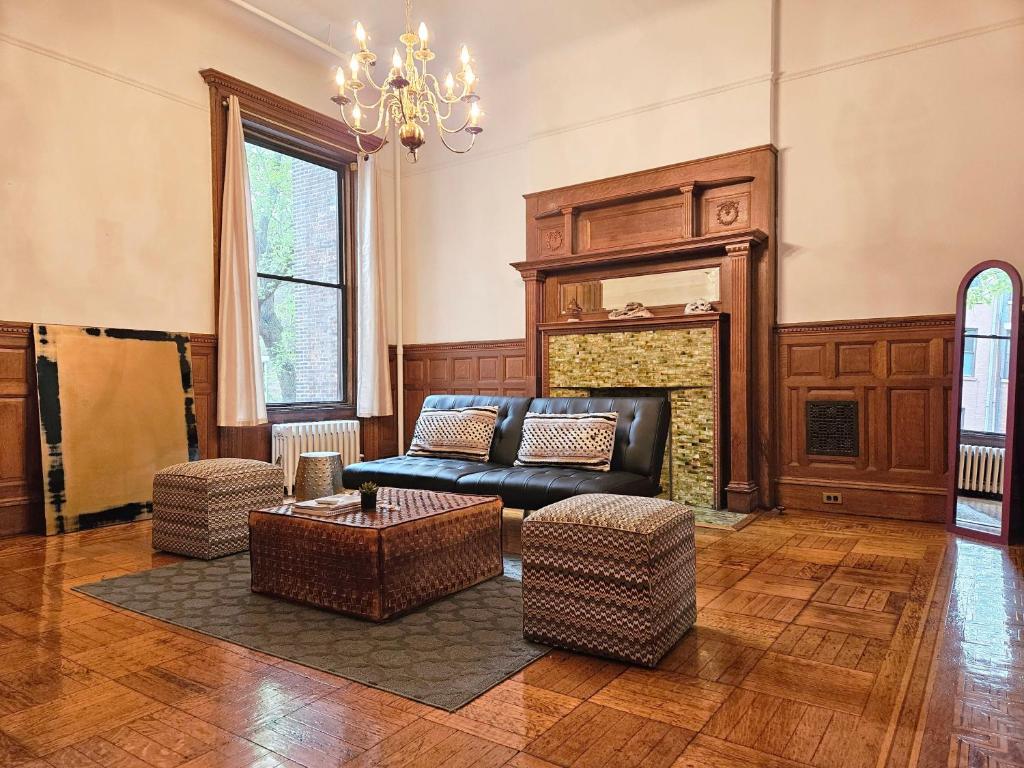 a living room with a couch and a fireplace at Entire floor in a charming townhouse in New York