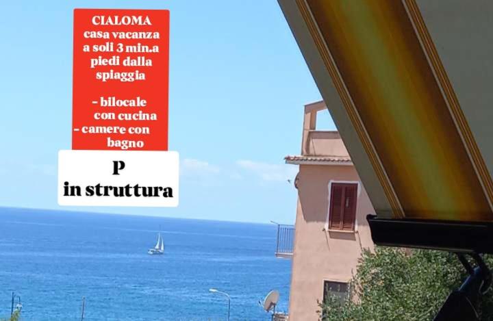 a sign on a building with a view of the ocean at Cialoma Full Green in Marina di Camerota