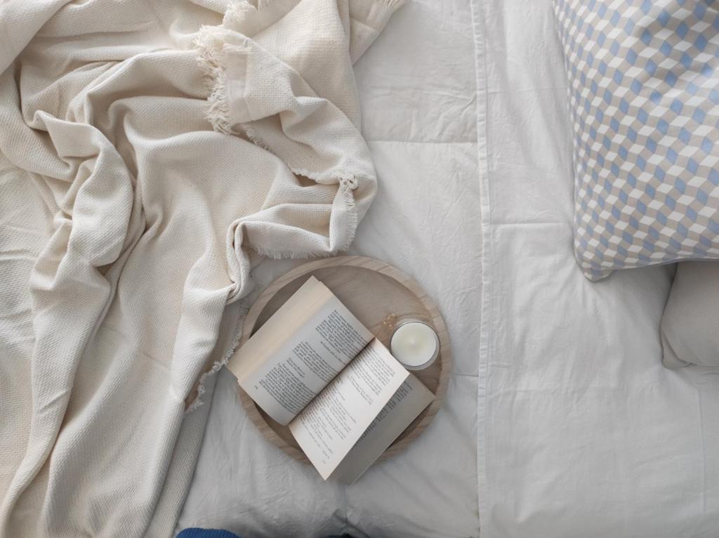 a book laying on top of a bed at Appartamenti Vacanze Villa Meo in Villafranca Tirrena