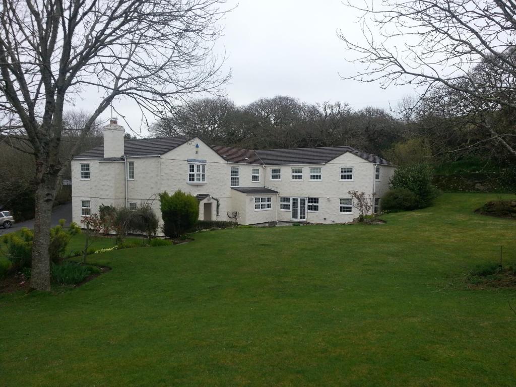 a large white house with a large yard at Rosmerryn in Constantine