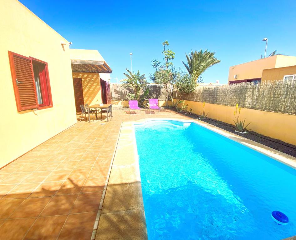 a swimming pool in the backyard of a house at Villa Marlau con piscina privada in La Oliva