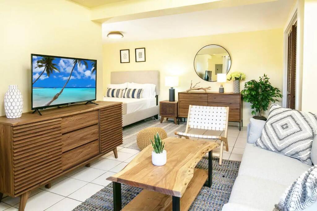 a living room with a television and a bedroom at Seaside Studio: Cruz Bay Gem in Enighed