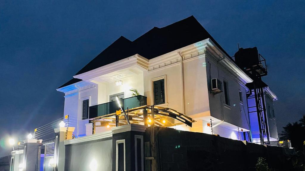 a white building with a black roof with lights on it at WHITEFIELD LUXURY APARTMENT in Orimedu