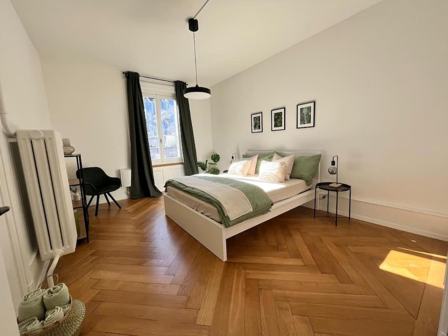 a bedroom with a bed and a wooden floor at Luxuswohnung in der Stadt Bern in Bern