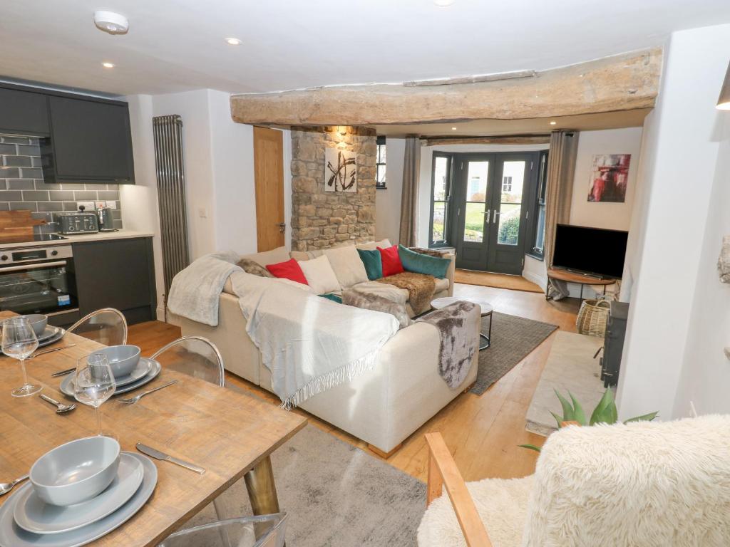 a living room with a white couch and a table at 4 Castle Terrace in Barnard Castle