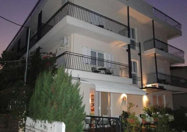 a large white apartment building with a balcony at Hanioti hotel in Hanioti