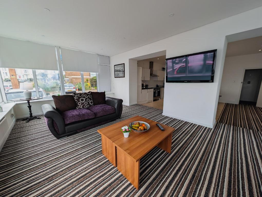 a living room with a couch and a coffee table at Bay & Harbour Holiday Apartments & rooms only in Weston-super-Mare