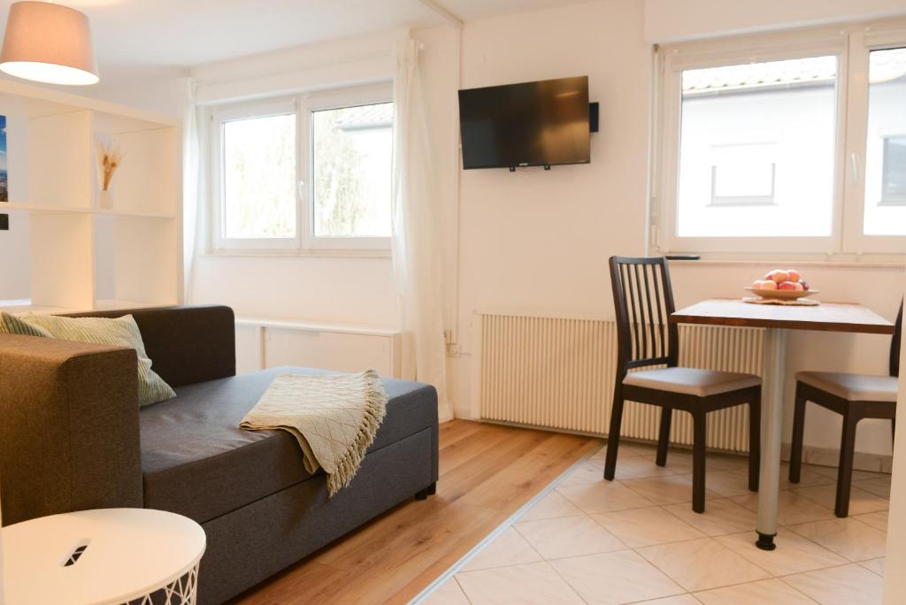 a living room with a couch and a table at Ferienwohnung Malou in Tettnang