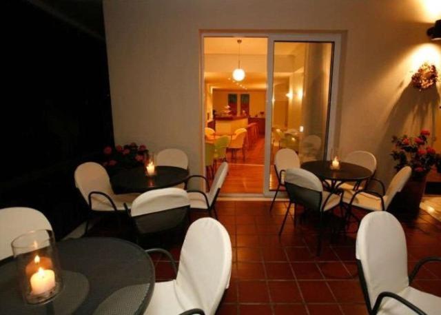 a room with tables and chairs and a living room at Hanioti hotel in Hanioti