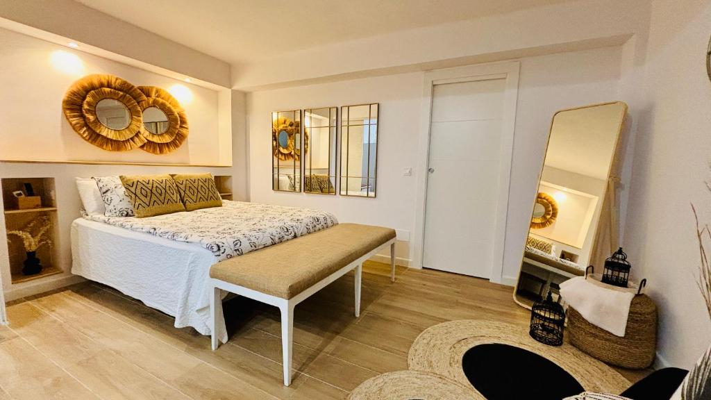 1 dormitorio con cama y espejo en EL PISITO SAND, a 700 metros del casco antiguo, en Marbella