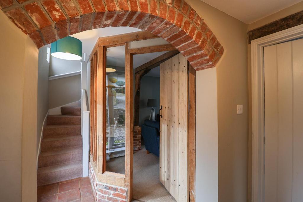 a hallway with an archway in a house at 1 The Old Coach House in Laxfield