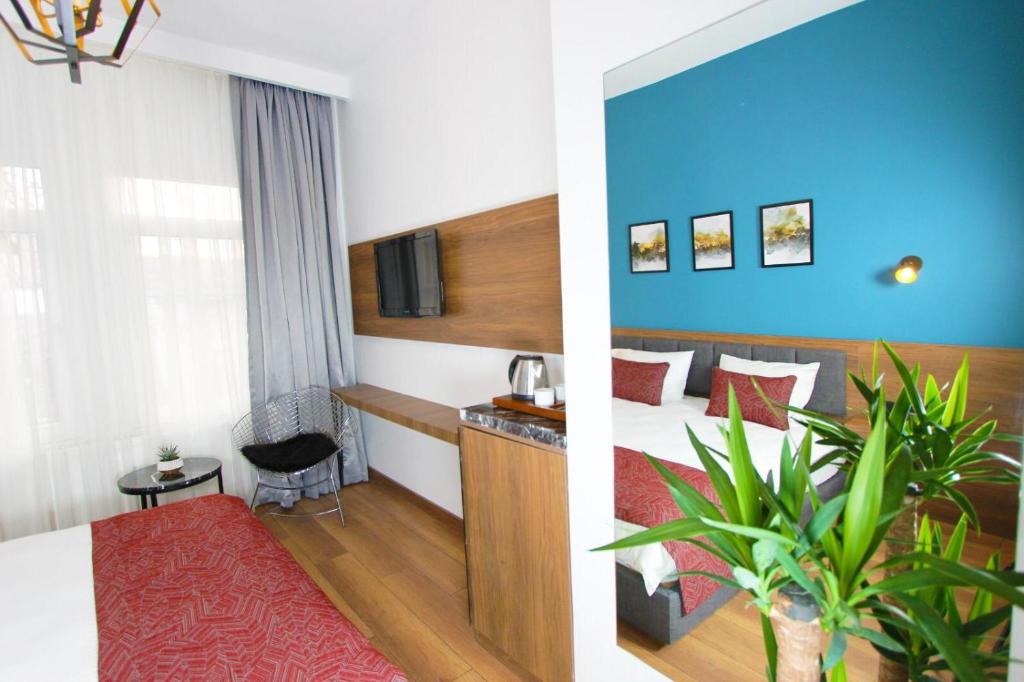a hotel room with a bed and a plant at Besiktas KonukEvi hotel in Istanbul