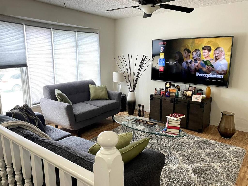 a living room with a couch and a flat screen tv at A Quiet Hideaway in Saskatoon in Saskatoon