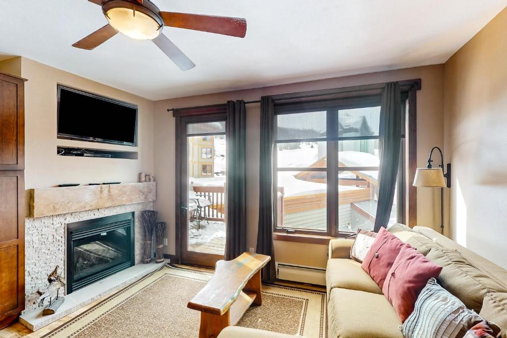 a living room with a couch and a fireplace at Village Hideaway in Copper Mountain