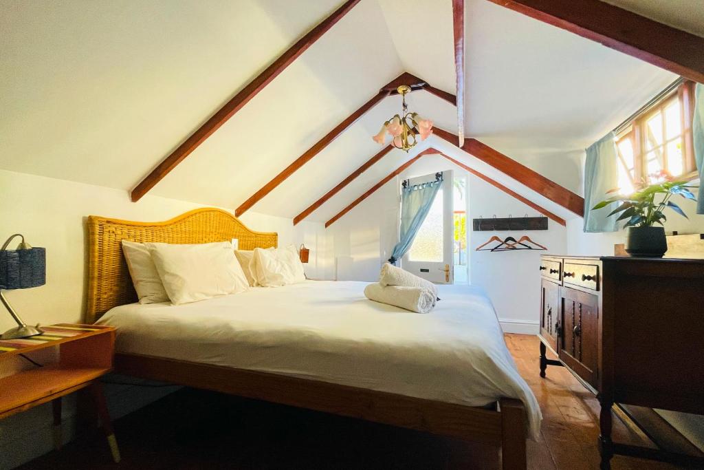 a bedroom with a large bed with a window at Ami Vine House in Cape Town
