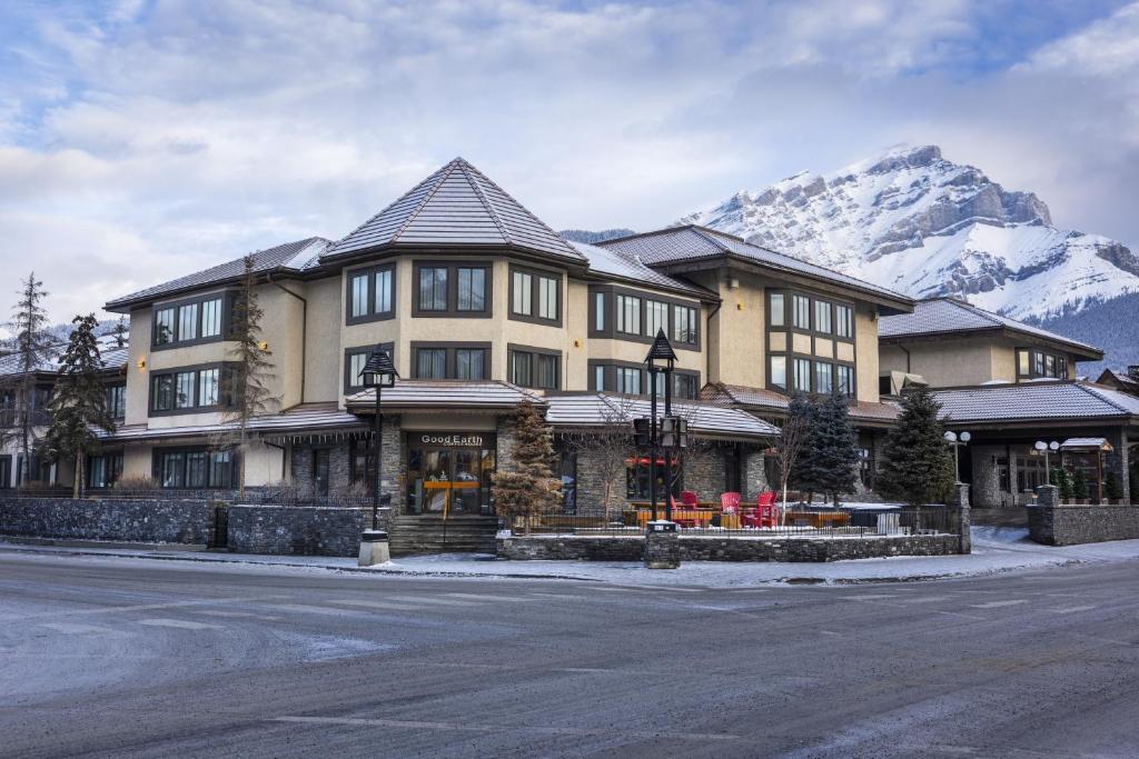 a large building on a street with a mountain at Elk + Avenue Hotel in Banff
