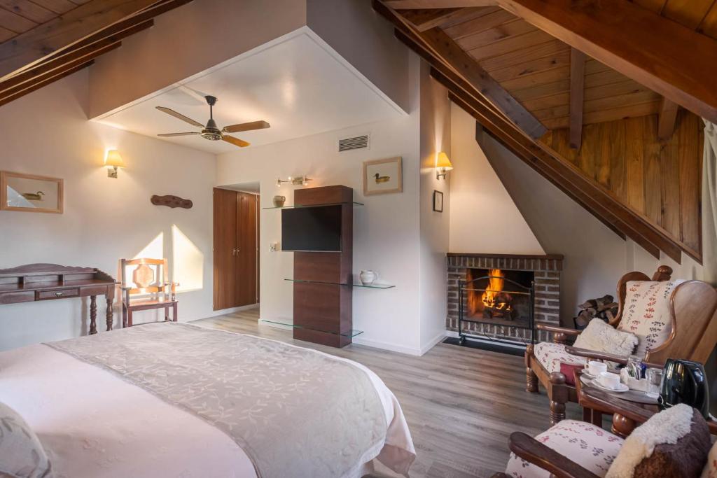 a bedroom with a bed and a fireplace at Le Chatelet in San Martín de los Andes