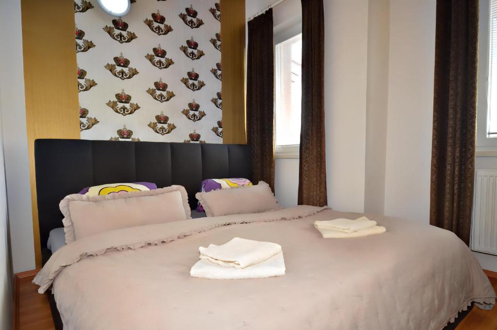 a bedroom with a large bed with white towels on it at Chilli apartment in Bratislava