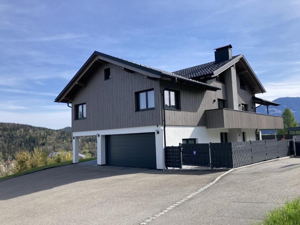 a large house with a garage in a driveway at Appartement Ariane in Frastanz
