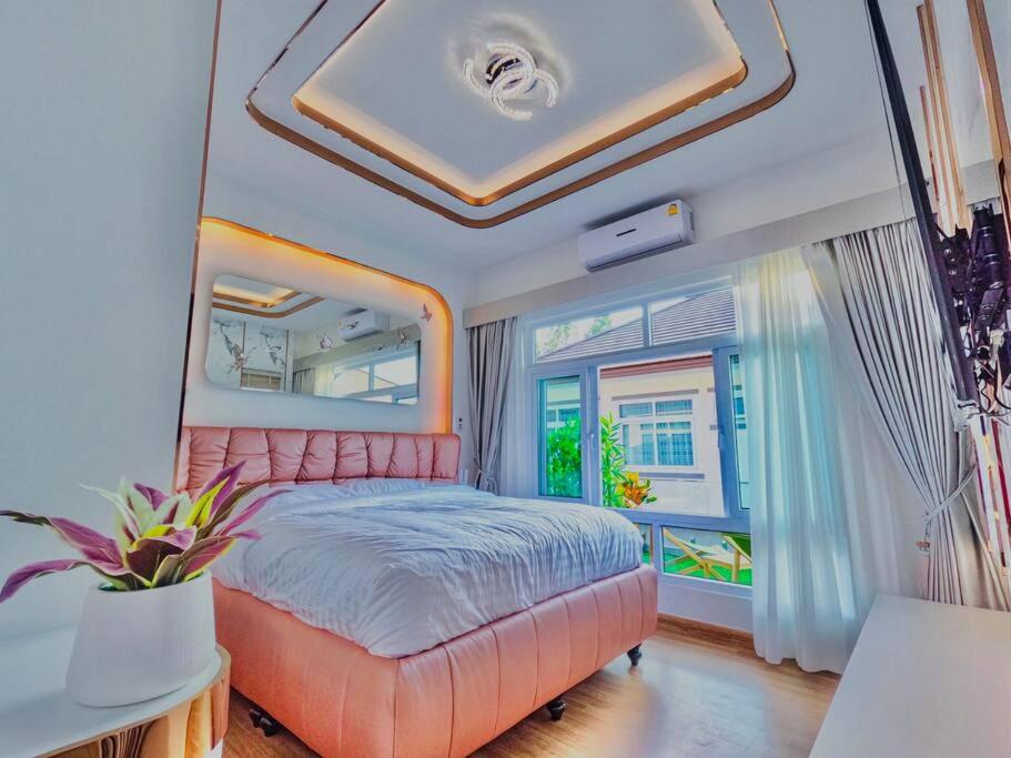 a bedroom with an orange bed and a window at Luxury Entire House short term rent In Buriram City for SongKran Festival in Buriram