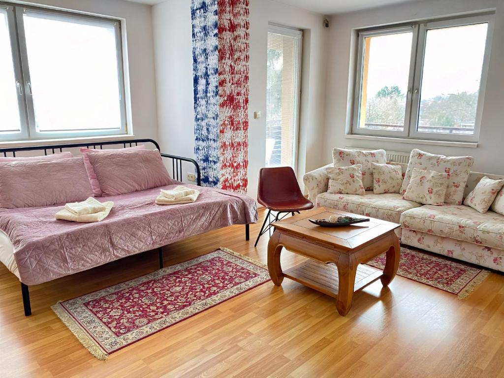 a living room with a couch and a table at Beauty apartment in Bratislava