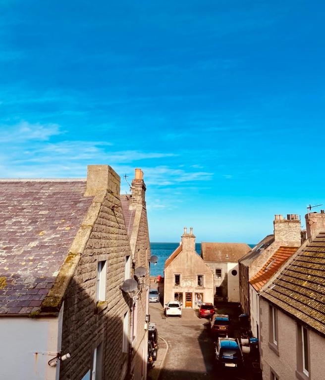 an aerial view of a town with houses and the ocean at The Crows Nest in Eyemouth