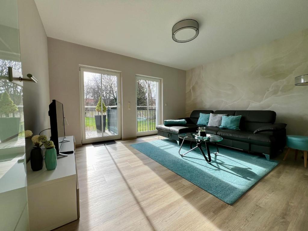 a living room with a couch and a table at Ferienwohnung Emil auf dem Zillehof in Ballenstedt in Ballenstedt