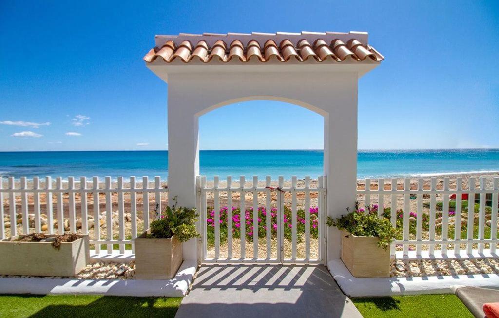 a white gazebo with plants inront of the beach at Casa con acceso directo a la playa de Mojácar in Mojácar