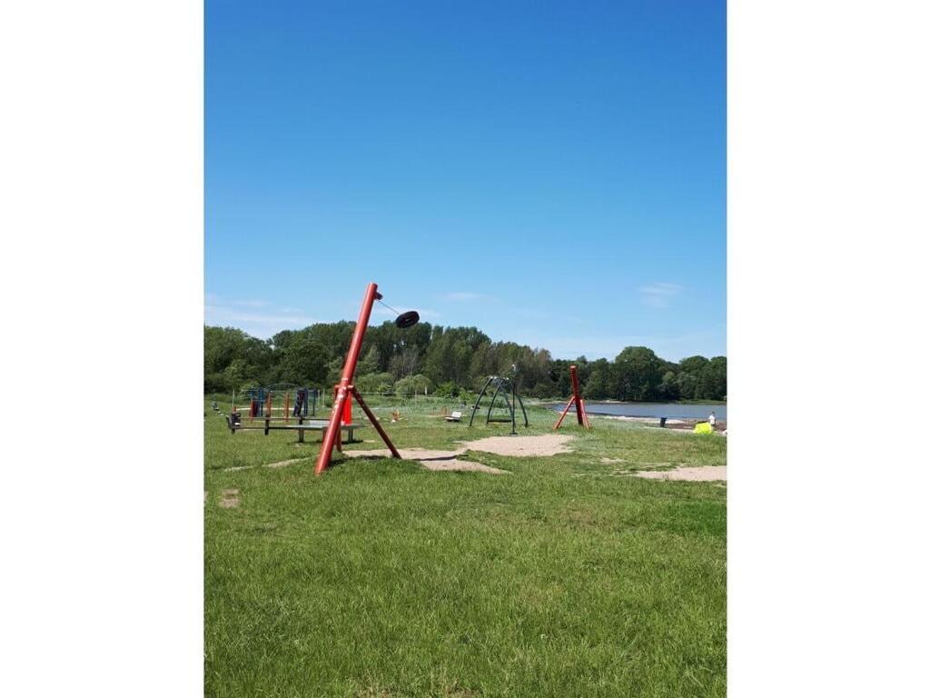 a park with a bunch of swings in the grass at Holiday apartment in Thuringia in Zierow