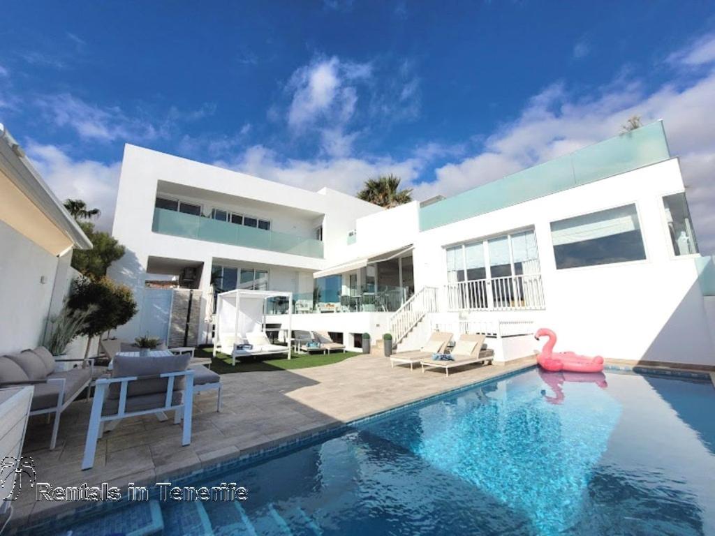 a swimming pool in front of a house at OCEAN MARINA GOLF Villa in San Miguel de Abona