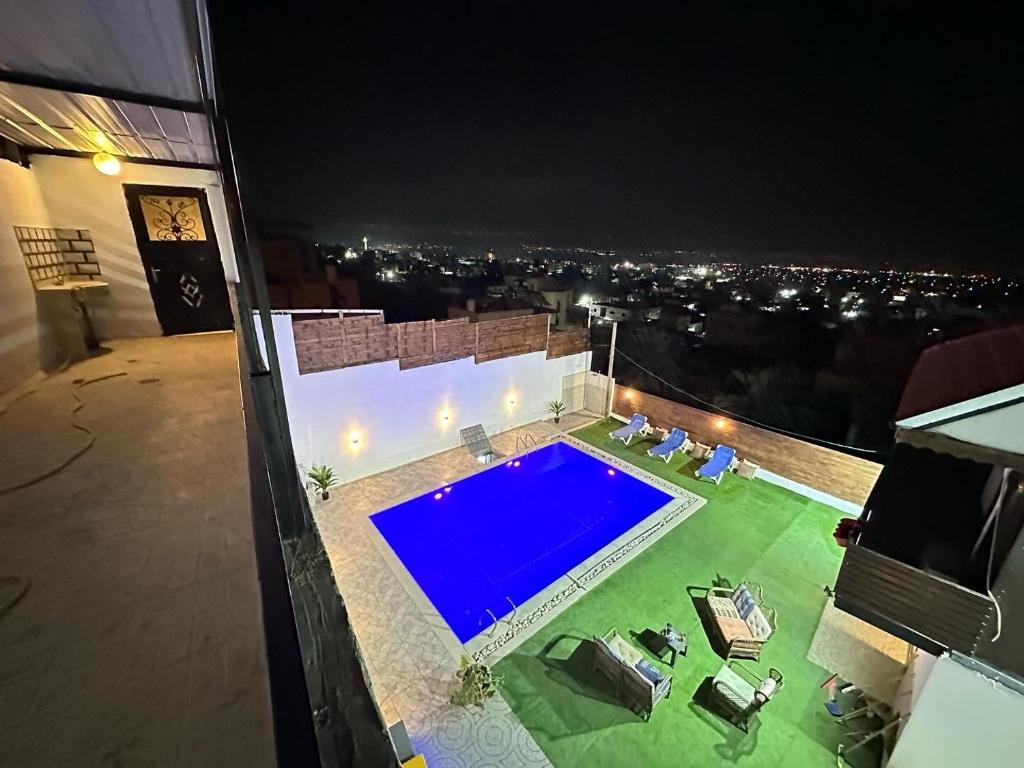 a swimming pool on top of a building at night at Jericho Palestine, Panorama Villa- View, Full Privacy & Pool in Jericho