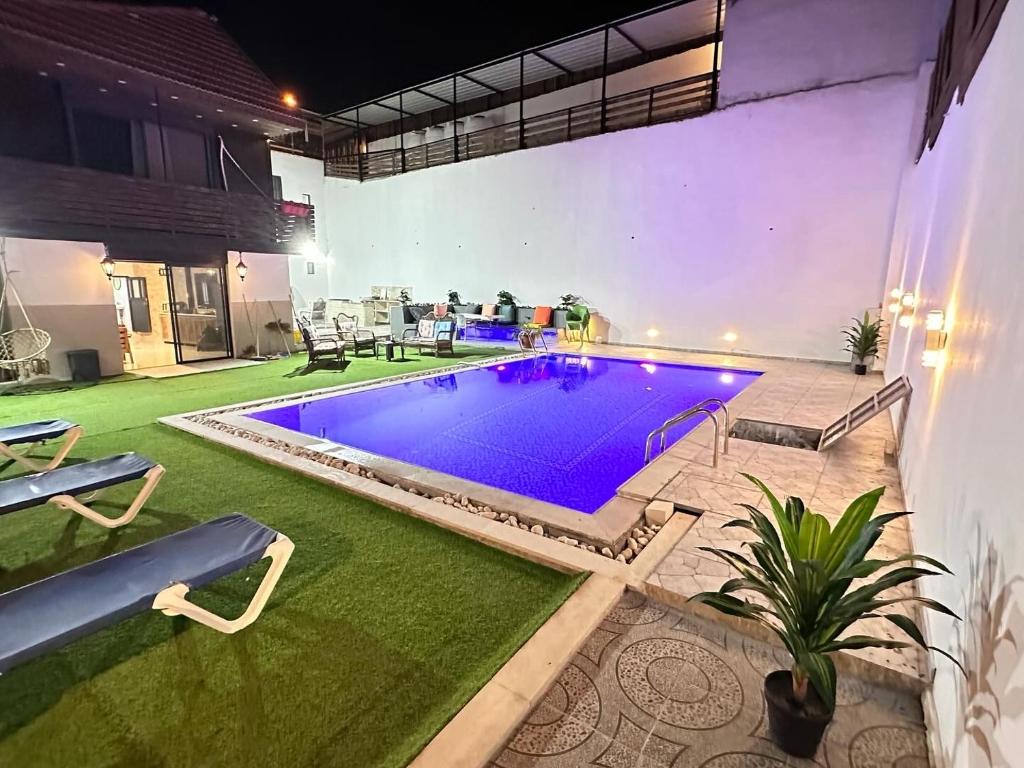 a swimming pool with purple lights in a yard at Jericho Palestine, Panorama Villa- View, Full Privacy & Pool in Jericho