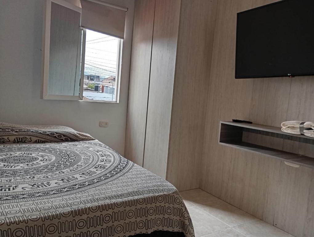 Postel nebo postele na pokoji v ubytování Apartaestudios Amoblados Pitalito