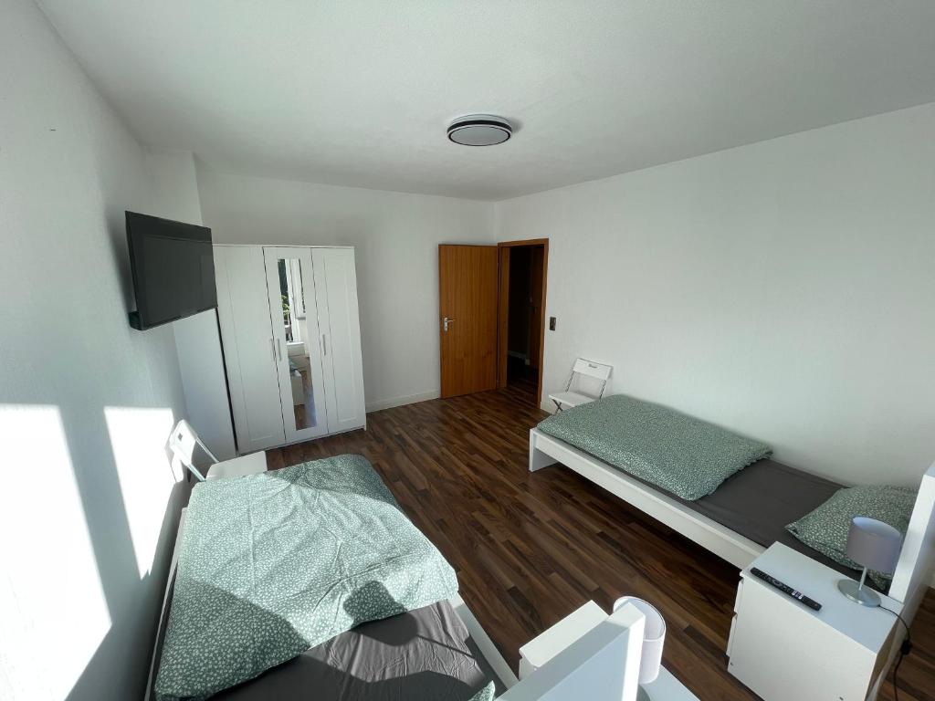 um pequeno quarto com 2 camas e uma secretária em CITY HAUS für 8 Personen em Bremen