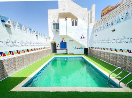 a swimming pool on the side of a cruise ship at Bakar House in Aswan