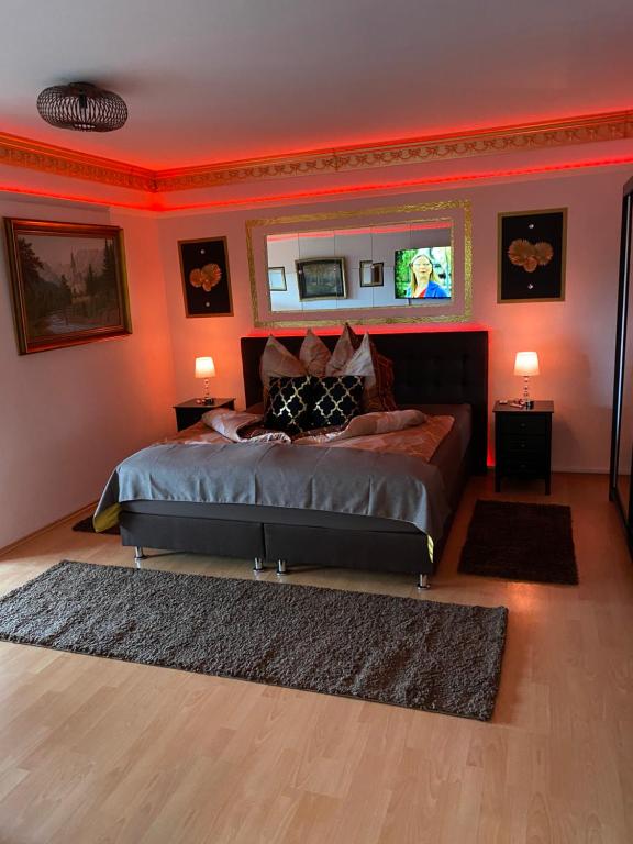 a bedroom with a bed in a room with red walls at Pension King Royal in Hamburg