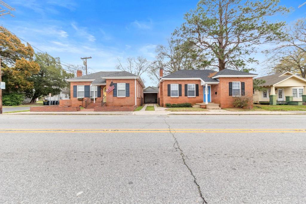 a brick house on a street with a street at Large Groups Welcome - 2 Homes Next Door in New Iberia