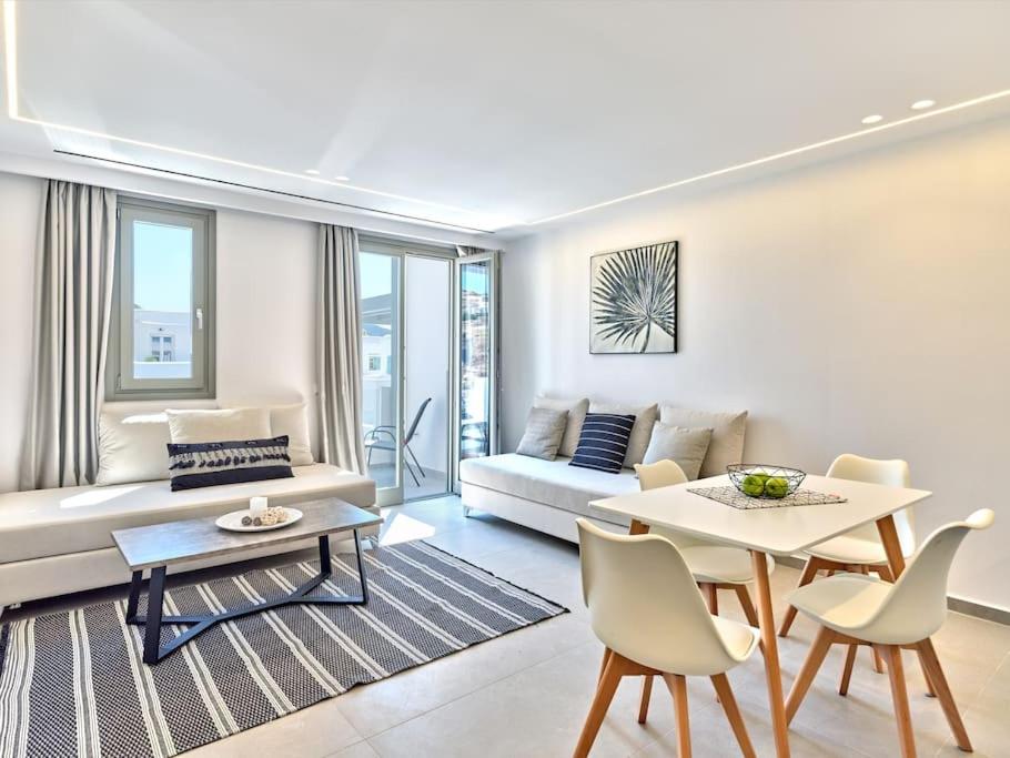 a living room with a couch and a table at Sapphire apartment - Paros Gem in Naousa