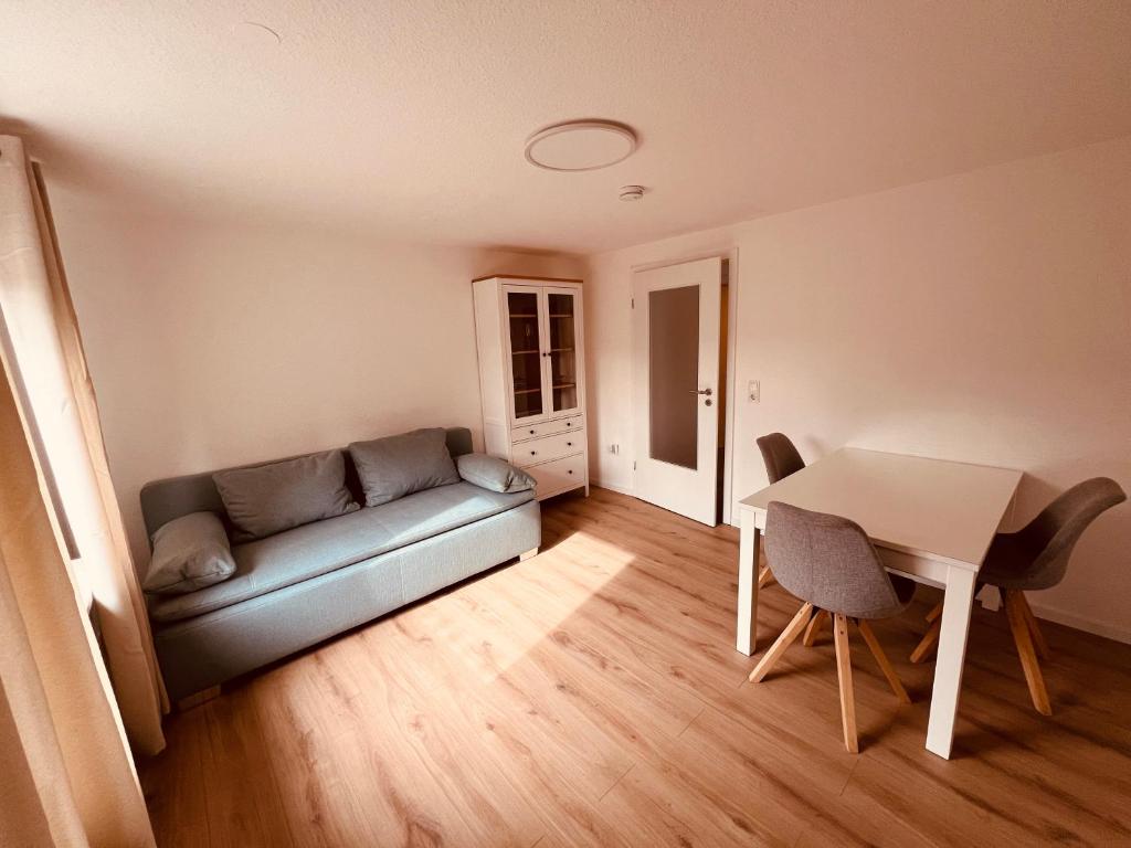 sala de estar con sofá y mesa en Ferienwohnung/Monteurwohnung Souterrain, neu renoviert, en Minden