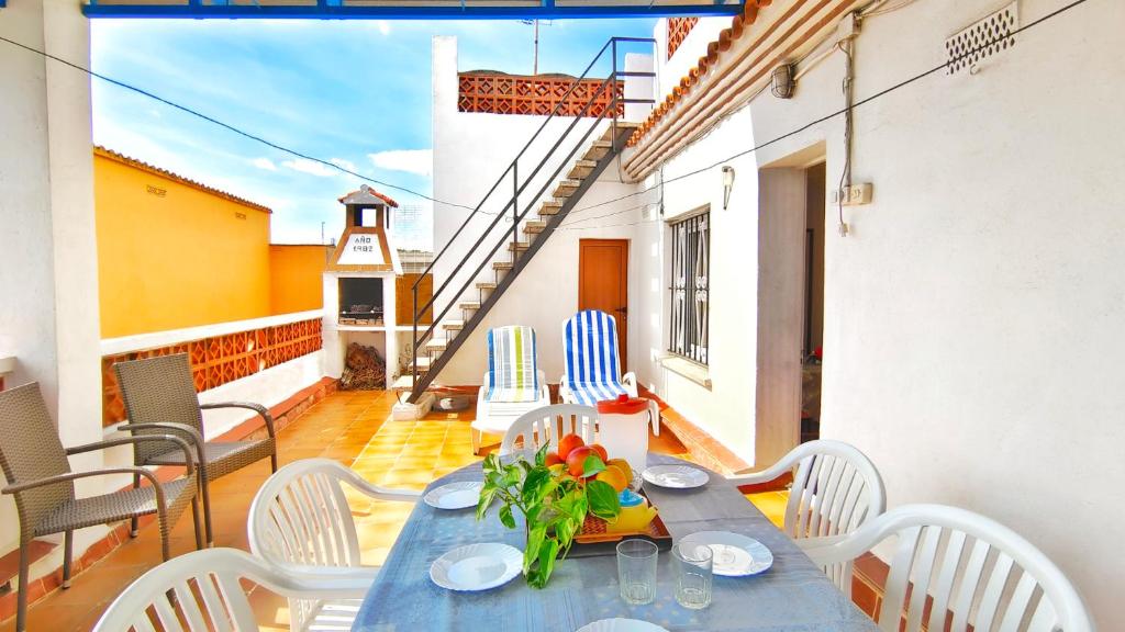 レスカラにあるVACAY Apartamento La Terrazaの青いテーブルと椅子、バルコニー(灯台付)