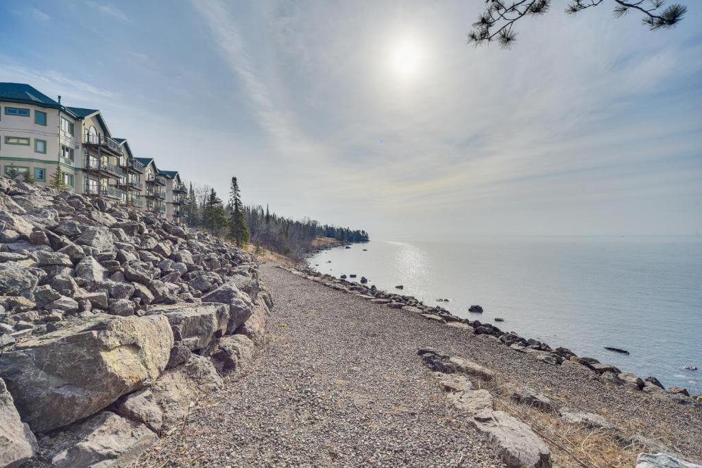 a stone wall next to a body of water at Waterfront Two Harbors Condo with Indoor Pool Access in Two Harbors