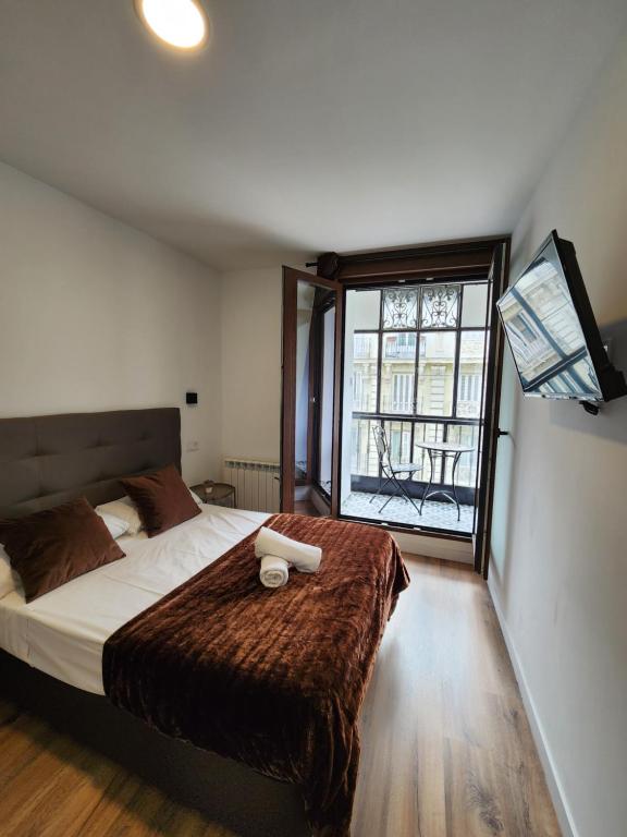 Postel nebo postele na pokoji v ubytování Hostal Arenal Madrid