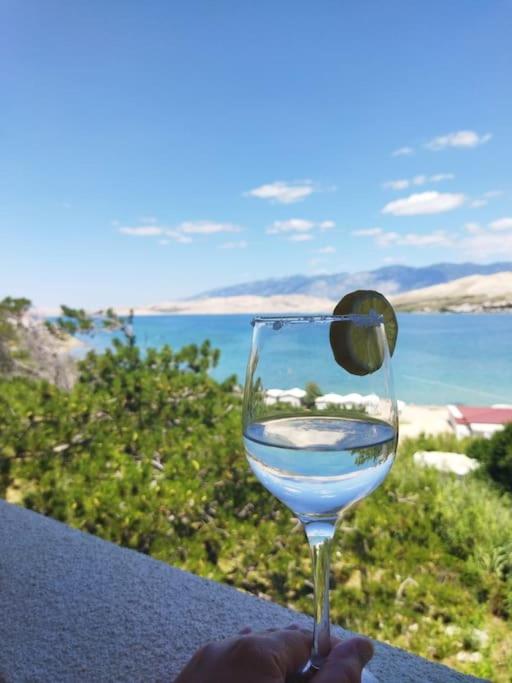 a person holding a wine glass with a lime in it at City Pag Apartment in Pag