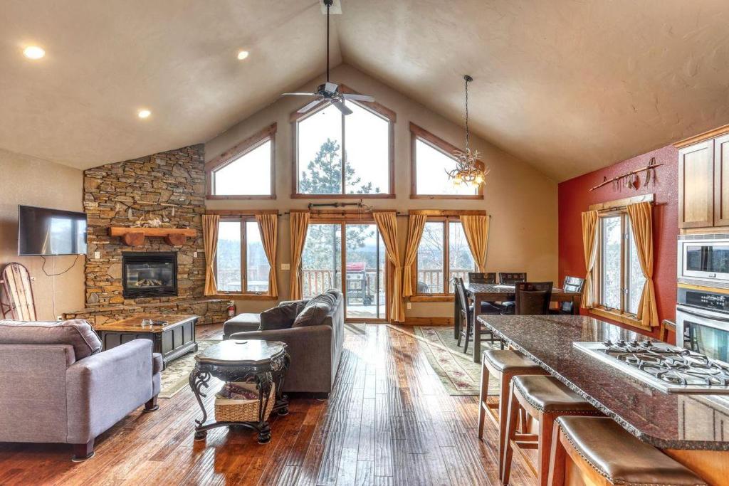 a large living room with a stone wall at Westwinds Lodge in Lead