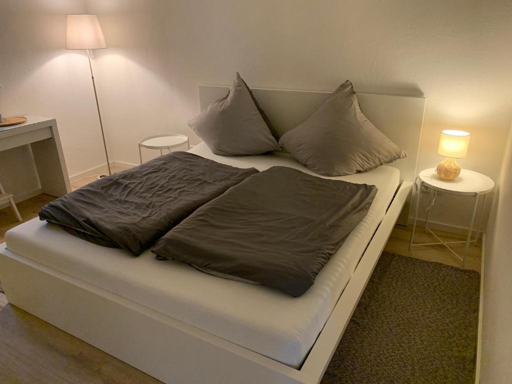 a bed with two pillows on it in a room at FeWo Weiß Mauchen in Schliengen