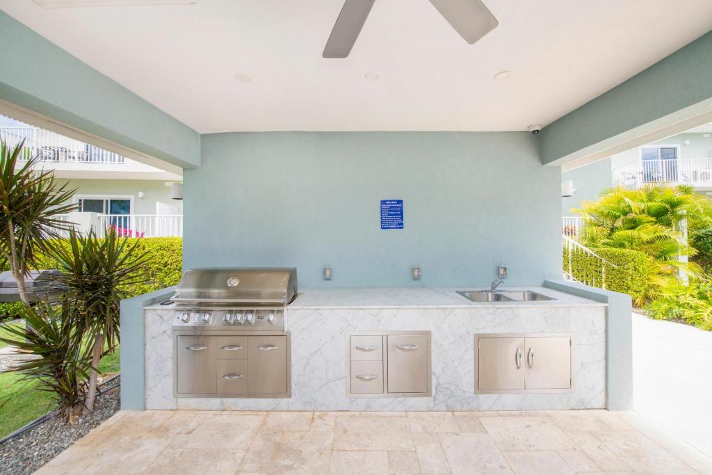 a large kitchen with a sink and a stove at Summertime Suites #49 in West Bay