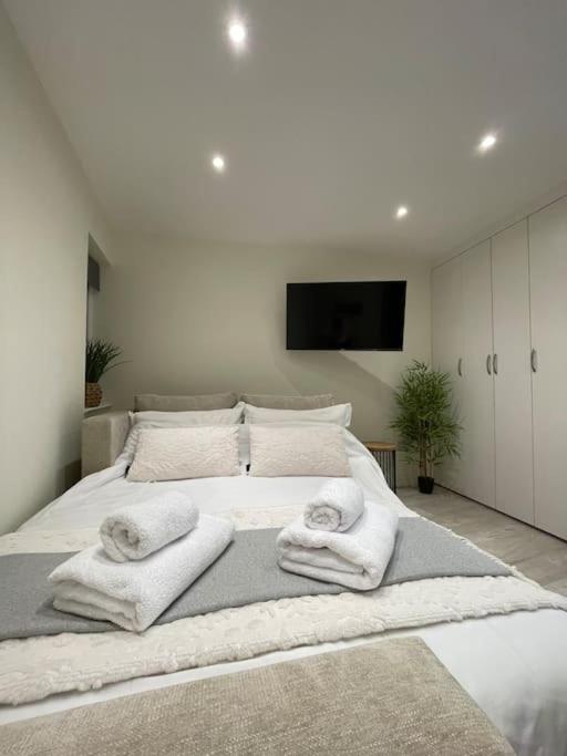 a bedroom with a bed with towels on it at Studio apartment in Bracknell